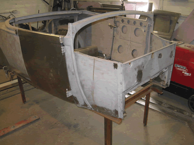 The damaged areas on the firewall and cowl have been repaired, and the body is now ready for the bodywork process.